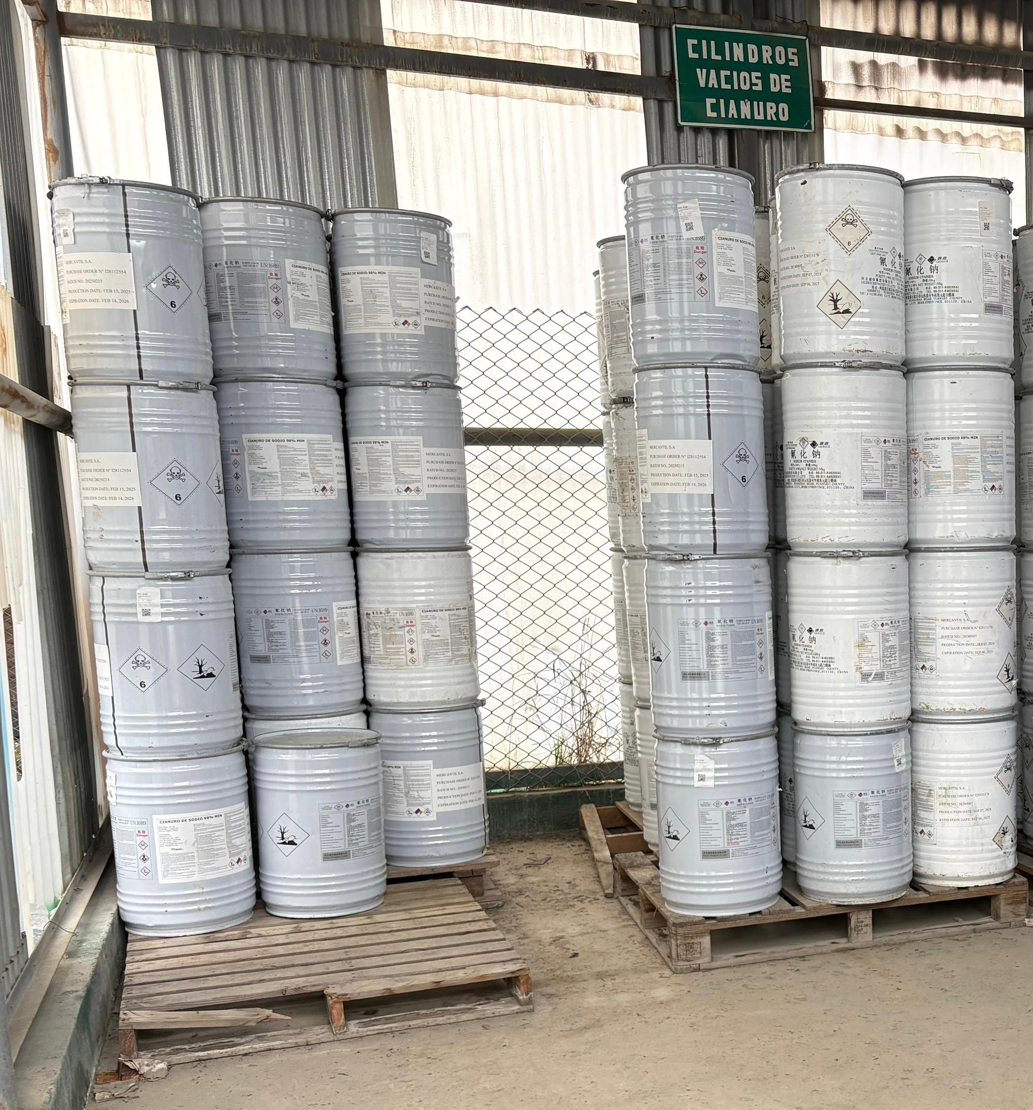 Barriles metálicos organizados en almacén industrial